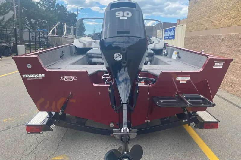 Slide: The Image of 2014 Tracker Pro Guide V-175 Combo boat with 90 HP engine, parked outdoors. - 4