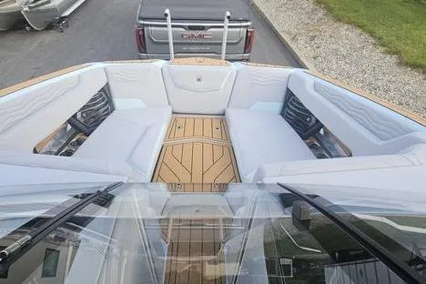 Slide: The Image of 2025 Nautique Super Air Nautique G23 boat with spacious seating and elegant design. - 11