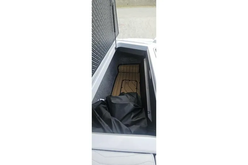 Slide: The Image of Storage compartment of 2025 Nautique Super Air Nautique G23 boat, featuring sleek interior design. - 15