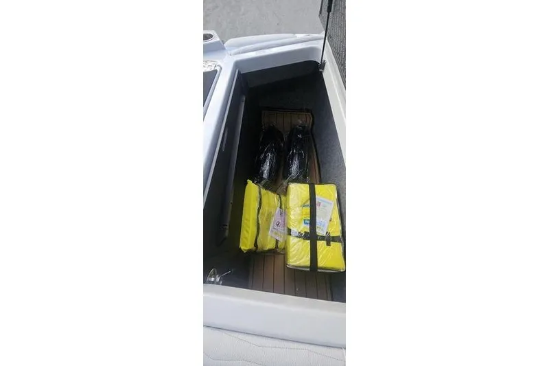 Slide: The Image of Storage compartment of 2025 Nautique Super Air Nautique G23 with life jackets and gear. - 16