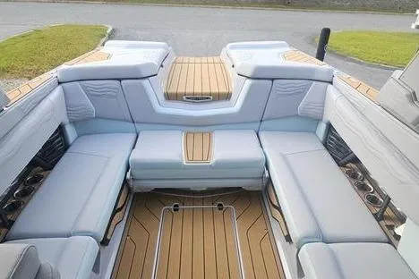 Slide: The Image of 2025 Nautique Super Air Nautique G23 interior with luxurious seating and teak flooring. - 3