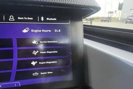 Slide: The Image of 2025 Nautique Super Air Nautique G23 dashboard displaying engine hours and diagnostics menu. - 6