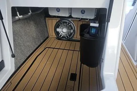 Slide: The Image of 2025 Nautique Super Air Nautique G23 interior with speaker and teak flooring. - 8