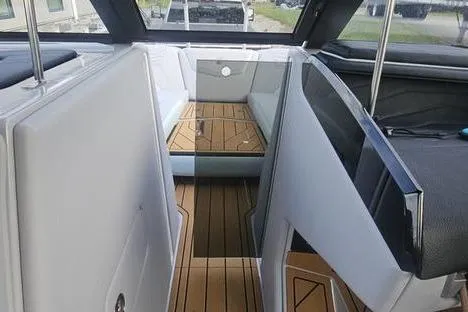Slide: The Image of 2025 Nautique Super Air Nautique G23 interior with sleek design and wood flooring. - 9