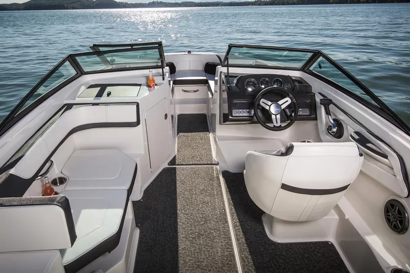 Slide: The Image of Manufacturer Provided Image: 2018 Sea Ray SPX 190 boat interior with seating and steering wheel on a lake. - 6