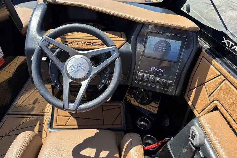 Slide: The Image of 2021 ATX Surf Boats 24 Type-S dashboard with steering wheel and digital display. - 13