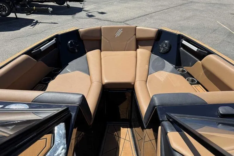 Slide: The Image of 2021 ATX Surf Boats 24 Type-S interior with tan seating and cup holders. - 14