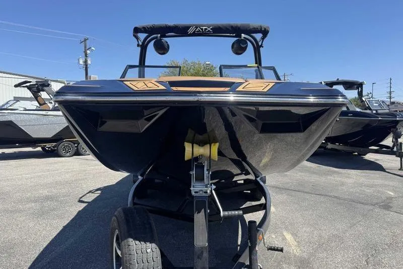 Slide: The Image of 2021 ATX Surf Boats 24 Type-S on trailer, front view under clear blue sky. - 4