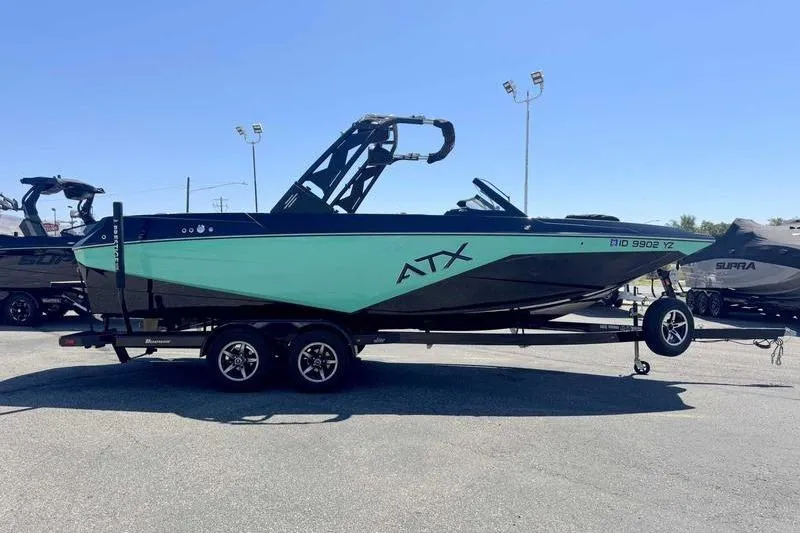 Slide: The Image of 2021 ATX Surf Boats 24 Type-S on trailer, displayed outdoors under clear sky. - 5