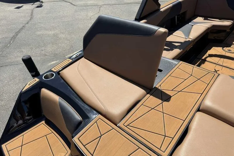 Slide: The Image of 2021 ATX Surf Boats 24 Type-S interior with tan and black seating, geometric design. - 6