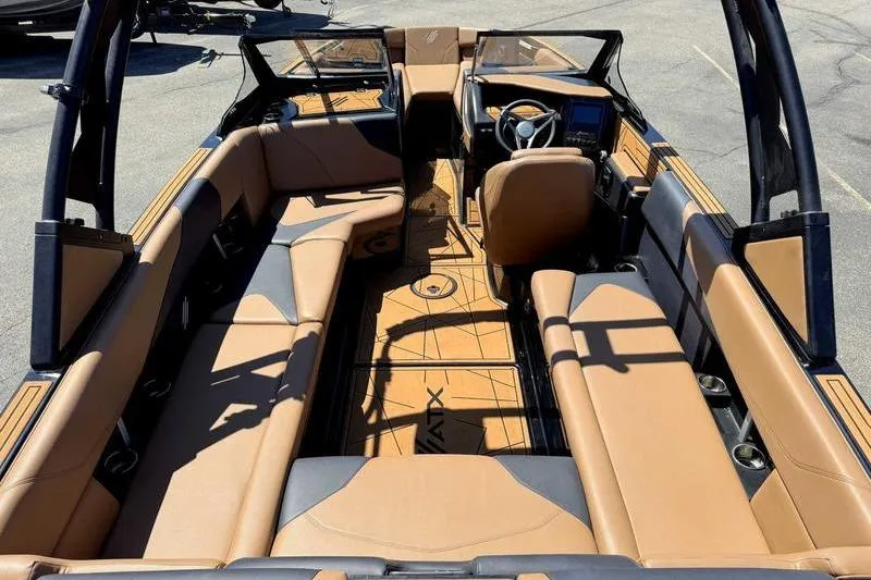 Slide: The Image of 2021 ATX Surf Boats 24 Type-S interior with tan seating and modern dashboard. - 8