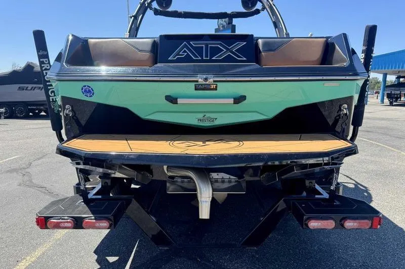 Slide: The Image of 2021 ATX Surf Boats 24 Type-S rear view with swim platform and branding. - 9
