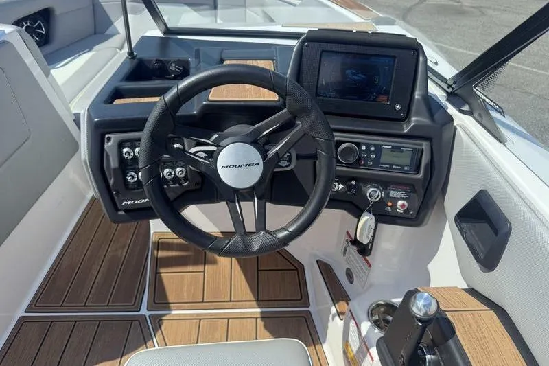 Slide: The Image of 2022 Moomba Mojo boat dashboard with steering wheel and control panel. - 11