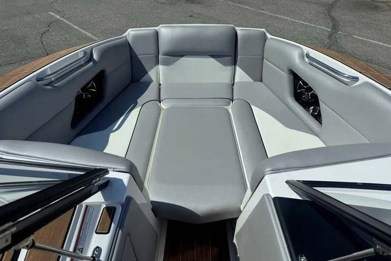 Slide: The Image of 2022 Moomba Mojo boat interior with gray seating and sleek design. - 14