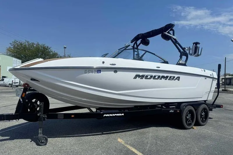 Slide: The Image of 2022 Moomba Mojo boat on trailer, parked outdoors under clear sky. - 4