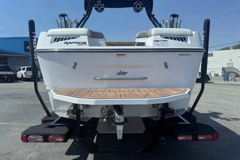 Slide: The Image of 2022 Moomba Mojo boat rear view with Raptor engine, parked on a trailer. - 9