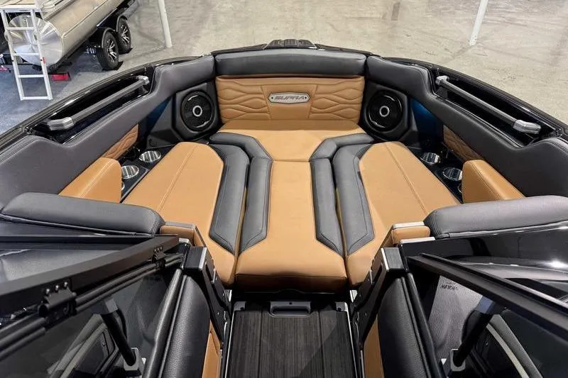 Slide: The Image of 2026 Supra SL boat interior with tan and black seating, premium sound system, and modern design. - 10
