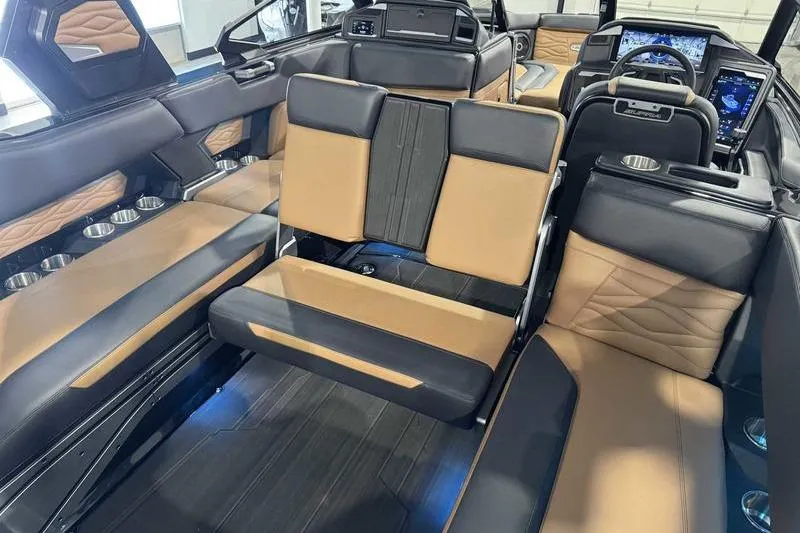 Slide: The Image of 2026 Supra SL interior with luxurious tan and black seating, modern dashboard, and cup holders. - 16