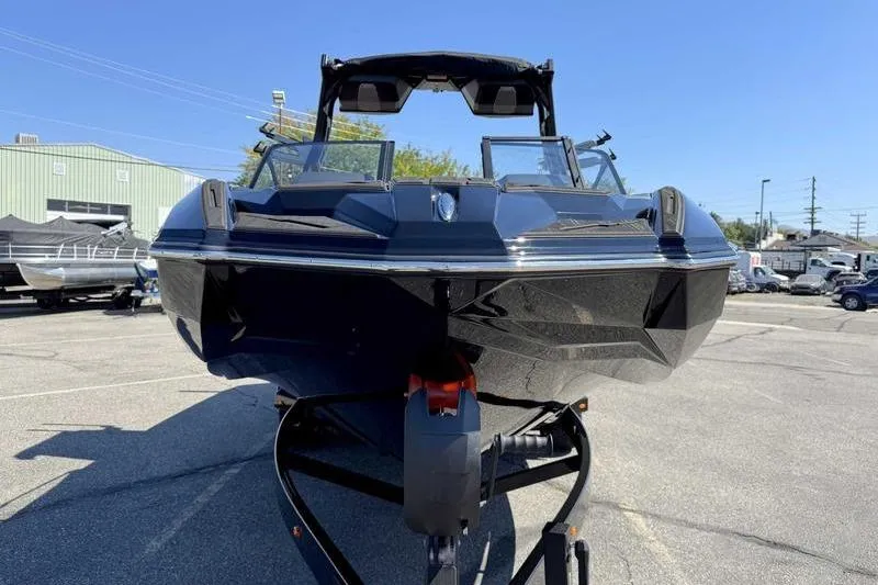 Slide: The Image of 2026 Supra SL boat in a parking lot, showcasing sleek black design and modern features. - 3