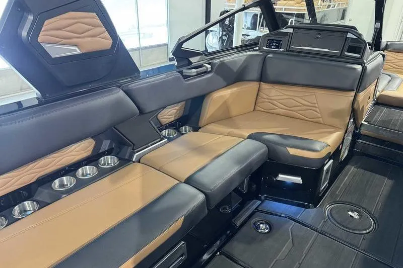 Slide: The Image of Luxurious interior of 2026 Supra SL boat with tan and black seating, cup holders, and modern design. - 9