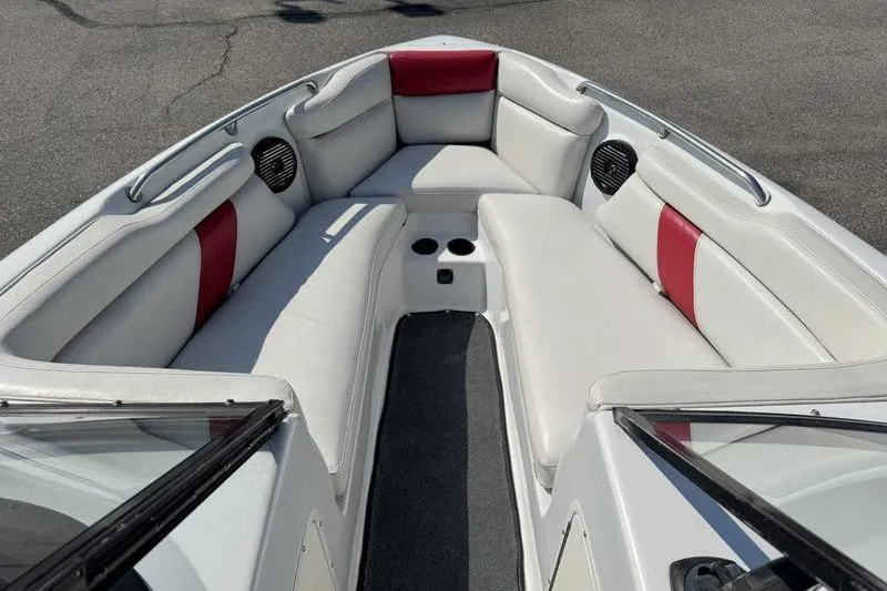 Slide: The Image of 2000 Tigé 2300V Limited boat interior with white and red seating. - 10