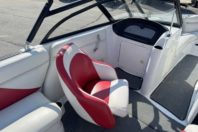 Slide: The Image of Interior of 2000 Tigé 2300V Limited boat with red and white seating. - 13