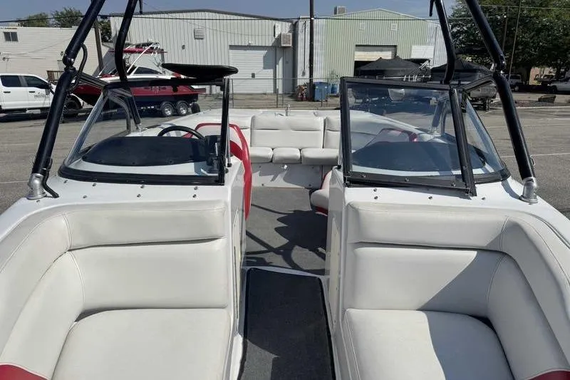 Slide: The Image of 2000 Tigé 2300V Limited boat interior with white seating and open cockpit view. - 14