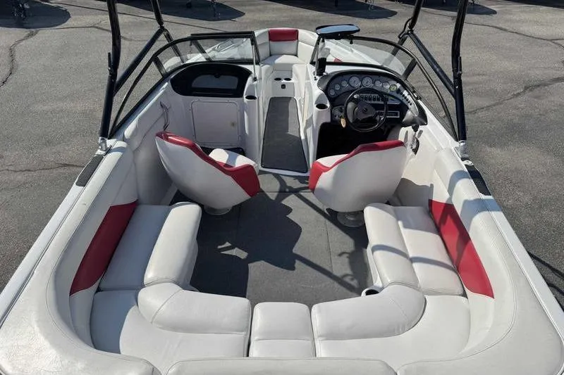 Slide: The Image of Interior of a 2000 Tigé 2300V Limited boat with white and red seating. - 3