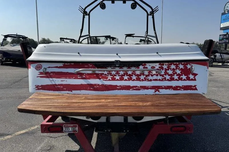 Slide: The Image of 2000 Tigé 2300V Limited boat with American flag design on the rear. - 5