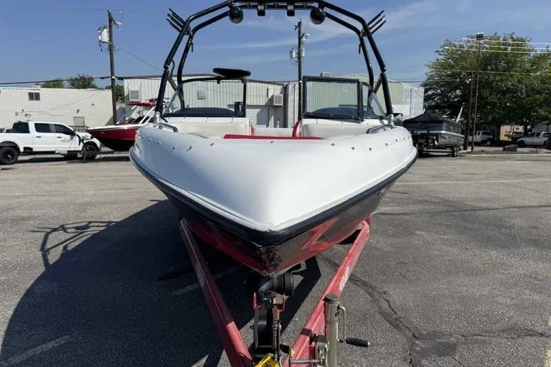 Slide: The Image of 2000 Tigé 2300V Limited boat on trailer in parking lot. - 9