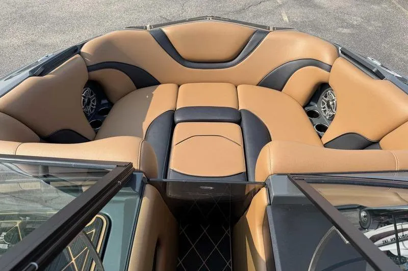 Slide: The Image of 2024 MB Alpha 23 boat interior with modern dashboard and tan leather seating. - 11