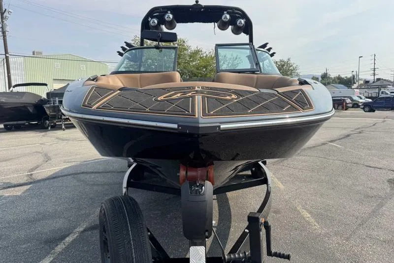 Slide: The Image of 2024 MB Alpha 23 boat on trailer in parking lot. - 4