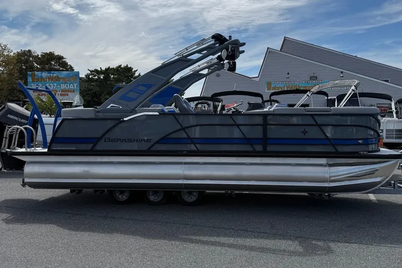 The Image of 2026 Berkshire 23RFX STS pontoon boat displayed outdoors, featuring sleek design and modern features. - 1