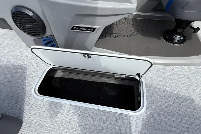 Slide: The Image of Open storage compartment on 2026 Berkshire 23RFX STS boat interior. - 10
