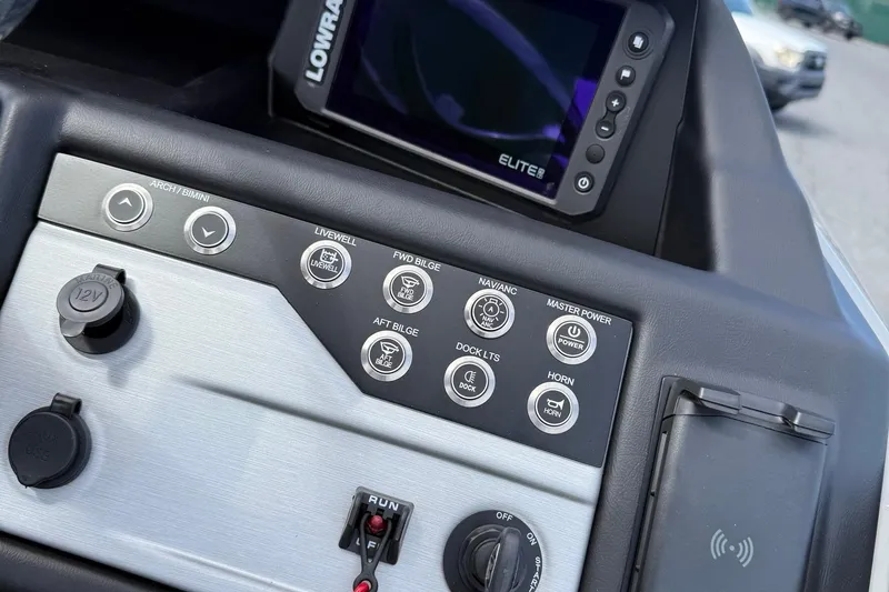 Slide: The Image of Control panel of 2026 Berkshire 23RFX STS boat with navigation and power switches. - 12