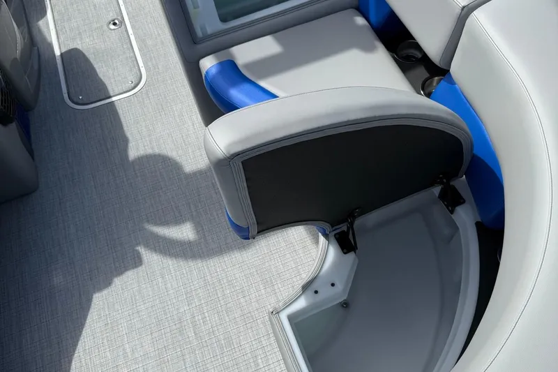Slide: The Image of 2026 Berkshire 23RFX STS boat interior with gray and blue seating and storage compartment. - 14