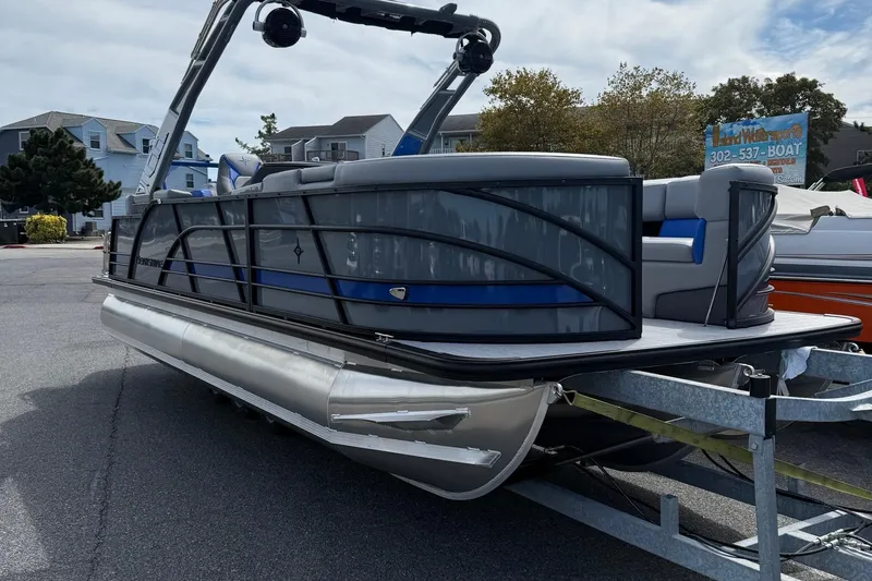 Slide: The Image of 2026 Berkshire 23RFX STS pontoon boat on trailer, parked outdoors. - 2