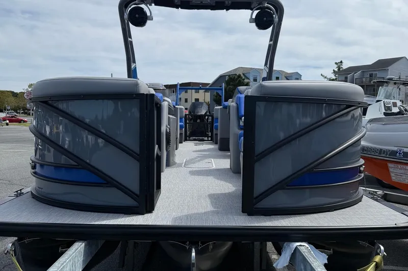 Slide: The Image of 2026 Berkshire 23RFX STS pontoon boat, sleek design, parked in marina setting. - 3