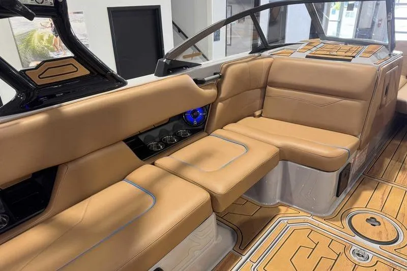 Slide: The Image of 2026 Moomba Mojo boat interior with tan leather seating and modern design. - 13