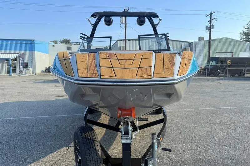 Slide: The Image of 2026 Moomba Mojo boat on trailer, featuring sleek design and wood accents. - 3