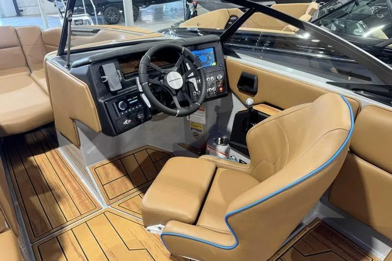 Slide: The Image of 2026 Moomba Mojo boat interior with tan leather seats and modern dashboard controls. - 7