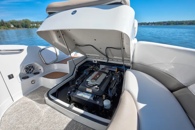 Slide: The Image of 2017 Crownline 285 SS boat engine compartment with open hatch, on a serene lake. - 13