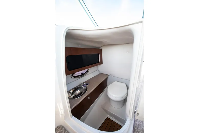 Slide: The Image of 2017 Crownline 285 SS boat interior bathroom with sink and toilet. - 5