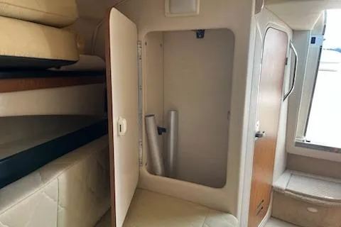 Slide: The Image of 2006 Sea Ray 260 Sundancer cabin interior with open storage compartment. - 13