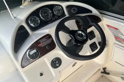 Slide: The Image of Steering wheel and dashboard of 2006 Sea Ray 260 Sundancer boat. - 2