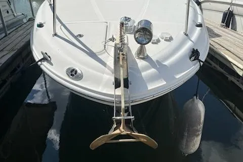 Slide: The Image of 2006 Sea Ray 260 Sundancer boat docked, showing anchor and deck details. - 21