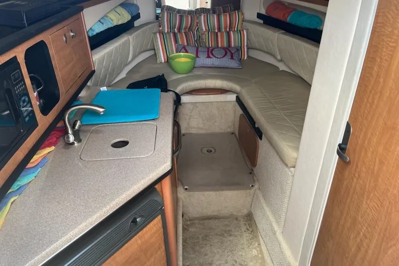 Slide: The Image of Interior of 2006 Sea Ray 260 Sundancer with kitchenette and cozy seating area. - 9