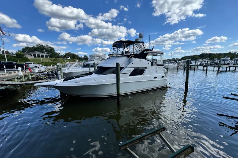 The Image of 1996 Silverton 372 Motor Yacht docked in sunny marina. - 1