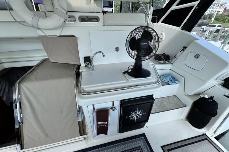 Slide: The Image of 1996 Silverton 372 Motor Yacht interior with sink, fan, and nautical decor. - 10