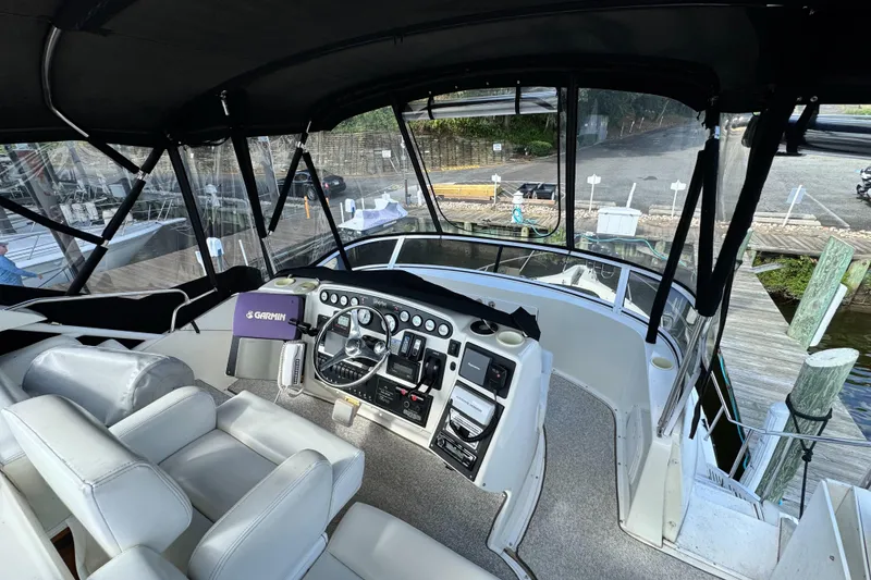 Slide: The Image of Interior view of 1996 Silverton 372 Motor Yacht helm with Garmin navigation system. - 11